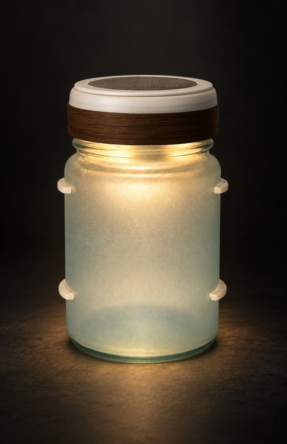The finished speaker lighting a frosted glass jar from within